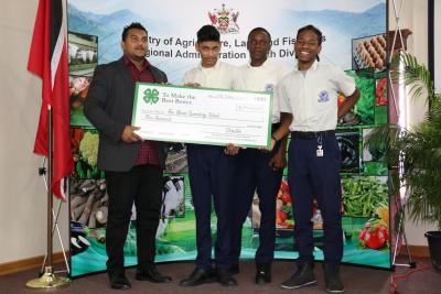 Parliamentary Secretary in the Ministry of Agriculture, Land and Fisheries (MALF), Senator Avinash Singh (left), hands over a winning cheque to three students of the Five Rivers Secondary School – Justin Budree, Elijah James and Christean Lopez – at the 4-H National Home Gardening Competition’s Prize Distribution Ceremony on Friday 27th October, 2017, at MALF’s Sugarcane Feeds Centre (SFC) in Longdenville. The school was the overall first place (Secondary School) recipient and winner of three (3) respective category prizes.