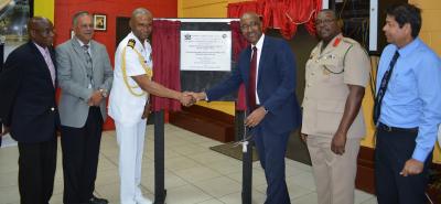 Chief of Defence Staff, Commodore Hayden Pritchard (left centre) shakes hands with the Minister of Public Utilities, Senator the Honourable Robert Le Hunte (right centre) after unveiling the commemorative plaque at the illumination ceremony of the Defence Force Reserves Playing Field. Also present (L-R) Mr. Anthony Bartholomew, Technical Advisor to the Minister of Public Utilities, Mr. Keith Sirju, Chairman of T&TEC, Colonel Colin Mitchell, Commanding Officer of the Trinidad and Tobago Defence Force and Mr. Kelvin Ramsook, General Manager of T&TEC.