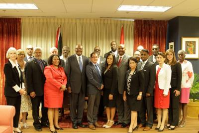 Caption: President of the Senate, Senator the Honourable Timothy Hamel-Smith and Speaker of the House, the Honourable Wade Mark (center) are surrounded by a Canadian delegation led by Senator Donald Meredith (wearing a red tie) who visited the Office of the Parliament on January 12, 2015 (Photo courtesy Office of the Parliament)