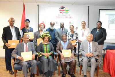 Caption: Members of the Trinidad and Tobago National Committee on Reparations pictured with their instruments of appointment. (Standing from L-R), Mr Anthony Birchwood; Der One Piankhi; Clyde Noel; Khafra Kambon; Andy Johnson; Theresa Neblett-Skinner; Chief Ricardo Bharath-Hernandez; Avril Belfon. (Seated from L-R) His Excellency Sir Edwin Carrington; Dr Verene Shepherd; Mr Aiyegoro Ome and His Excellency Ambassador Mervyn Assam. (File Photo)
