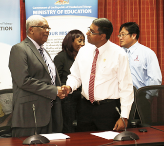 Caption: Minister of Education, the Honourable Anthony Garcia (left) and President of the Trinidad and Tobago Unified Teachers Union (TTUTA), Davanand Sinanan shake hands following a press conference hosted at the Ministry's Head Office in St. Clair. It was disclosed at the press conference that the Education Ministry and TTUTA have reached an agreement for the supervision of the S.E.A 2016. (Photo courtesy guardian.co.tt)