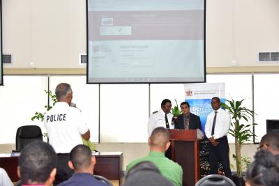 Caption: A member of the police service fields a question to Senator the Hon. Rohan Sinanan, Minister of Works and Transport following a demonstration of the new online service by Mr. Clive Clarke, IT Director of the Ministry (pictured to the right of Minister Sinanan). Transport Commissioner Mr. Wayne Richards, (at left of Minister) also answered questions from the audience. (Photo courtesy the Ministry of Works and Transport)