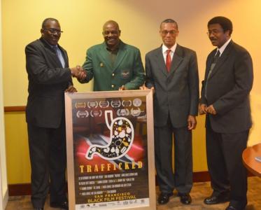 Caption: Minister of National Security Major General (Ret.) the Honourable Edmund Dillon (left) is presented with a commemorative screening poster from the San Francisco Black Film Festival held from June 16th to 19th, 2016. Looking on are Minister in the Ministry of National Security Senator the Honourable Dennis Moses and Permanent Secretary of the Ministry of National Security Mr. Simeon Yearwood.