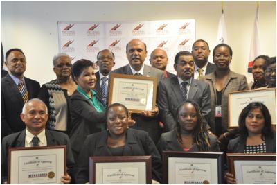 Caption: National Training Agency’s (NTA) Launch of the Workforce Assessment Centres (WAC) at Conference Room, Ministry of Tertiary Education and Skills Training, Level 18, International Waterfront Centre, 1A Wrightson Road, Port of Spain on Monday October 27 2014: Front Row L-R WAC Approval Certificate Recipients. 2nd Row L-R, Director of NTA Dr. Wayne Haywood, Permanent Secretary – Ministry of Tertiary Education and Skills Training, Mrs. Angela Sinaswee-Gervais, WAC Approval Certificate recipients, Tertiary Education and Skills Training Minister Fazal Karim, NTA CEO Mr. Steve Arman, NTA Chairman Mr. Kelvin Mahabir and Deputy Permanent Secretary – Ministry of Tertiary Education and Skills Training, Ms. Jasmine Pascall. (Photo courtesy: Ministry of Tertiary Education and Skills Training)