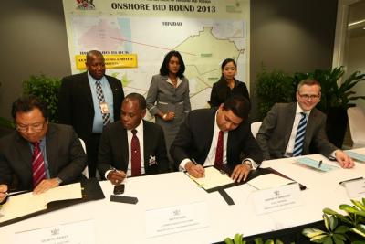 Caption: Energy Minister Kevin Ramnarine (seated second from right) signs an onshore exploration license with Range Resources Limited for the St Mary’s Block. Also seated (from left) are: Lindsay Gillette, Chairman, Petrotrin; Ian Fletcher, Commissioner of State Lands; Nick Beattie, CFO, Range Resource. Looking on are representatives of the Ministry of Energy and Energy Affairs(from left): Selwyn Lashley, Permanent Secretary; Indira Ramkissoon, Director, Legal; Jade Saney, Attorney at Law. (Photo courtesy Ministry of Energy and Energy Affairs)