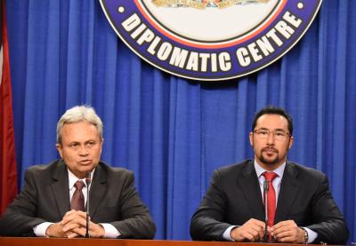 Photo Caption: (L-R) The Honourable Colm Imbert, Minister of Finance and the Honourable Stuart Young, Minister in the Office of the Prime Minister and Minister in the Ministry of the Attorney General and Legal Affairs, address the media at the weekly Post Cabinet Press Briefing. (Photo Courtesy: Office of the Prime Minister)