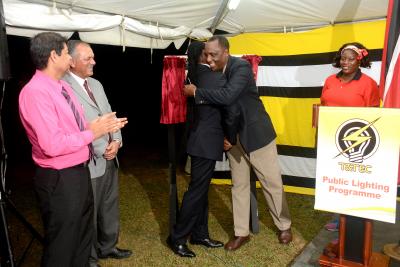 Caption: (L-R) Mr. Kevin Ramsook, General Manager, T&TEC; Mr. Keith Sirju, Chairman, T&TEC; the Honourable Fitzgerald Hinds, Minister of Public Utilities embraces Brigadier General (Retired) Ancil Antoine, MP for D’Abadie/O’Meara at the Illumination Ceremony at the Samaroo Village Recreation Grounds. (Photo Courtesy: Trinidad and Tobago Electricity Commission)