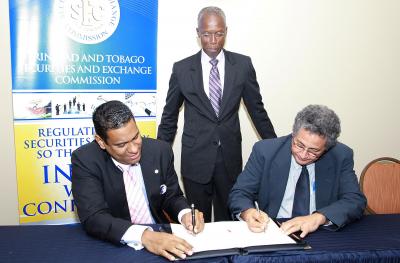 Caption: President of the Securities Dealers Association of Trinidad and Tobago (SDATT), Gregory Hill and Chairman of the Trinidad and Tobago Securities Exchange Commission (TTSEC), Prof. Patrick Watson sign a Protocol which will govern the relationship between the SDATT and the TTSEC at their first stakeholder outreach meeting at the Courtyard Marriot on January 8. Looking on is Chief Executive Officer of the TTSEC, Wainwright C. Iton