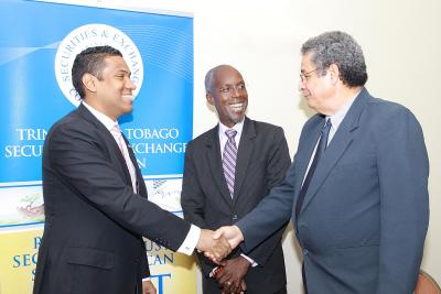 Caption: President of the Securities Dealers Association of Trinidad and Tobago (SDATT), Gregory Hill shakes hands with Chairman of the Trinidad and Tobago Securities Exchange Commission (TTSEC), Prof. Patrick Watson after signing a Protocol at their first stakeholder outreach meeting at the Courtyard Marriot. Looking on is Chief Executive Officer of the TTSEC, Wainwright C. Iton