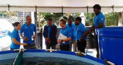 Caption: Minister of Agriculture, Land and Fisheries, Senator the Honourable Clarence Rambharat (3rd from left) being informed about the tagging process by the volunteers with the Turtle Village Trust. Looking on is the CEO, Atlantic LNG, Mr. Nigel Darhow (4th from left). (Photo courtesy the Ministry of Agriculture)