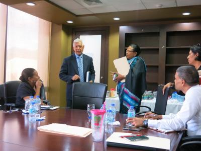 Caption: Port of Spain Mayor, His Worship Joel Martinez engages the attention of PS Bailey-Sobers (right), and other Ministry personnel including Mrs Lorraine Reyes-Borel, Executive Director of the Social Displacement Unit (seated left) and Mr Vijay Gangapersad, Chief Technical Officer (seated right). Also looking on is a representative of the Port of Spain City Corporation. (Photo courtesy the Ministry of Social Development and Family Services)