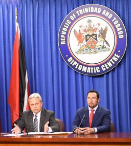 Photo Caption: (L-R) The Honourable Colm Imbert, Minister of Finance and the Honourable Stuart Young, Minister in the Office of the Prime Minister and Minister in the Ministry of the Attorney General and Legal Affairs, address the media at the weekly Post Cabinet Press Briefing. (Photo Courtesy: Office of the Prime Minister)