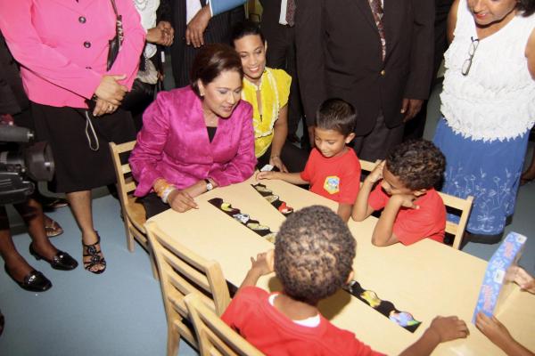 Caption: Prime Minister, Kamla Persad-Bissessar and Chairman of the Tunapuna-Piarco Regional Corporation engage in childplay with these children from the the Bon Air ECCEC. Caption: Prime Minister, Kamla Persad-Bissessar and Chairman of the Tunapuna-Piarco Regional Corporation engage in childplay with these children from the the Bon Air ECCEC.