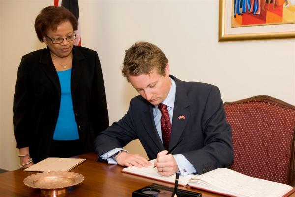 H.E. British High Commissioner to Trinidad and Tobago Arnthur Snell signs the visitors book at the Ministry of Foreign Affairs. Looking on is Permanent Secretary Margaret Parillion. H.E. British High Commissioner to Trinidad and Tobago Arnthur Snell signs the visitors book at the Ministry of Foreign Affairs. Looking on is Permanent Secretary Margaret Parillion.